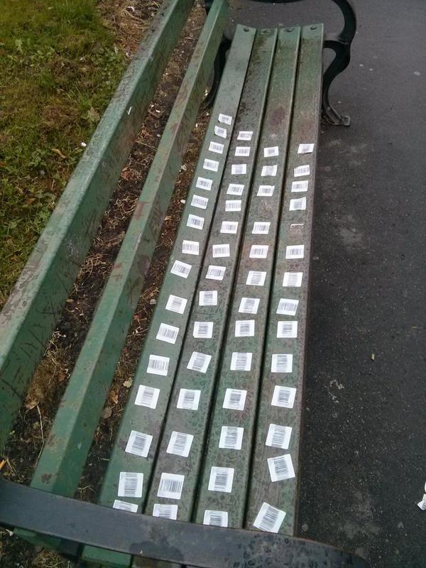 Someone was bored. (Bench covered with bar code stickers)  - embedded image 